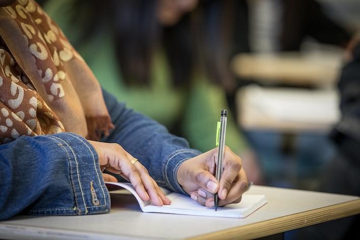 a student writing in a notebook